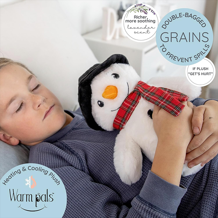 Child resting with a microwavable lavender-scented snowman plush toy designed for warmth and comfort therapy.