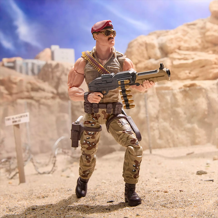 Hasbro G.I. Joe Sgt Slaughter action figure in desert camo with beret and large weapon, posed ready for battle.
