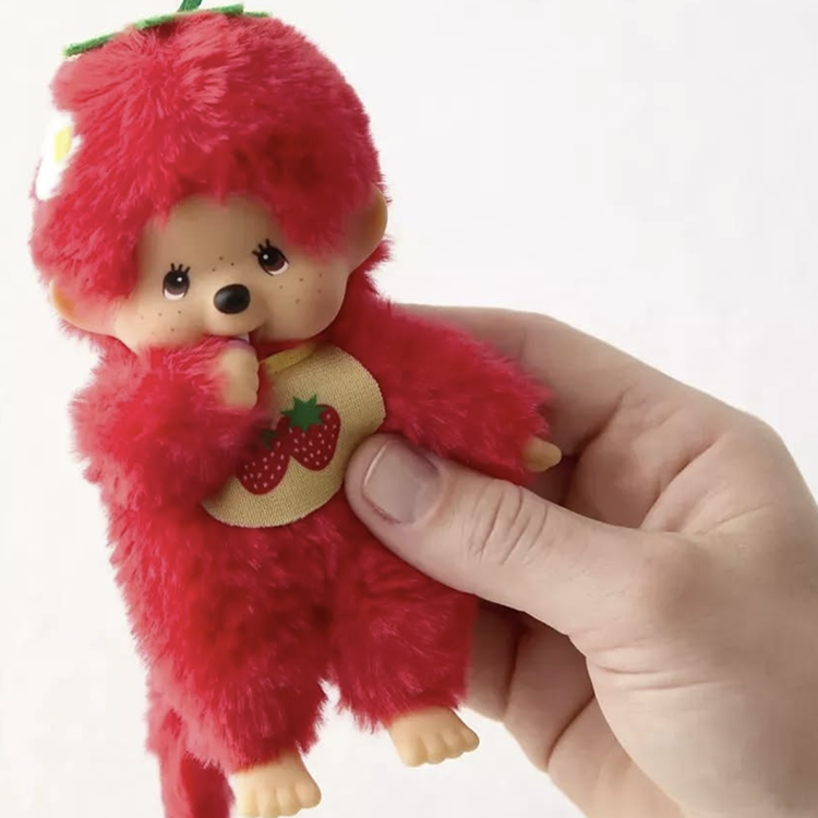 Sekiguchi Monchhichi plush in bright strawberry red with soft fur and detailed plastic face held in hand
