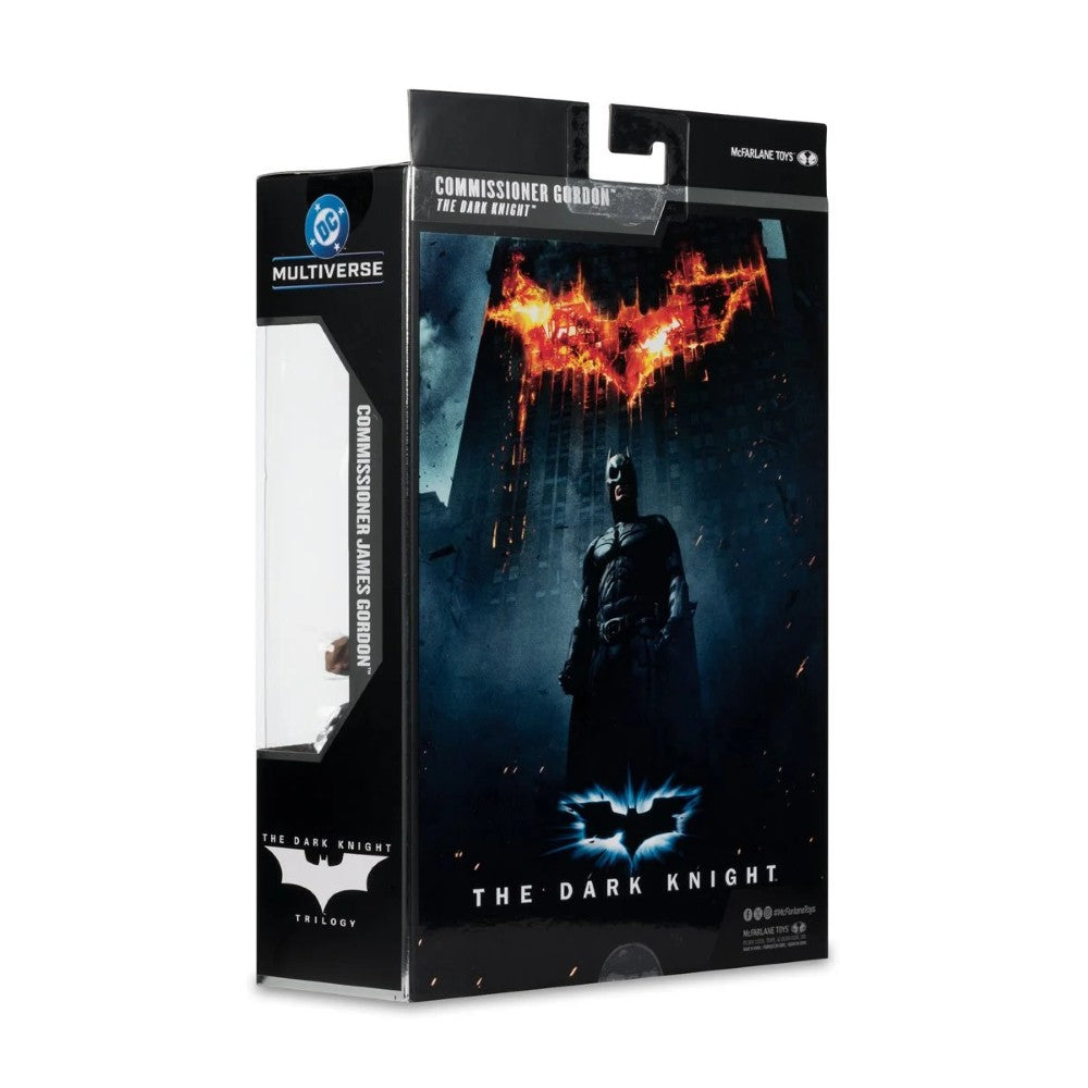 Batman The Dark Knight: Commissioner Groot 1/12 Scale Action Figure in its original Multiverse packaging, featuring artwork of Batman with the Batsuit and a fiery Bat-symbol.