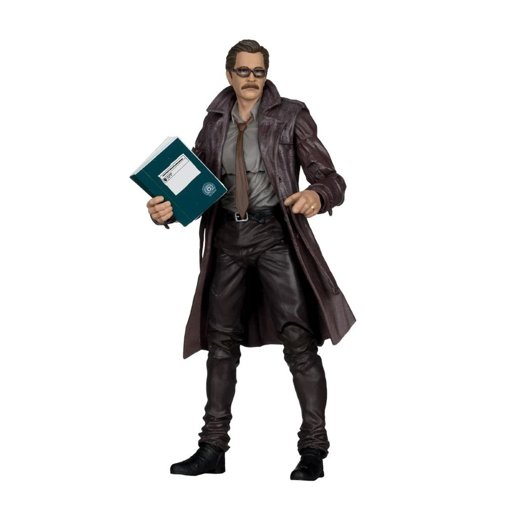 A collectible action figure of a man wearing a long dark brown trench coat, gray shirt, brown tie, and black pants, holding a teal folder, set against a plain white background.