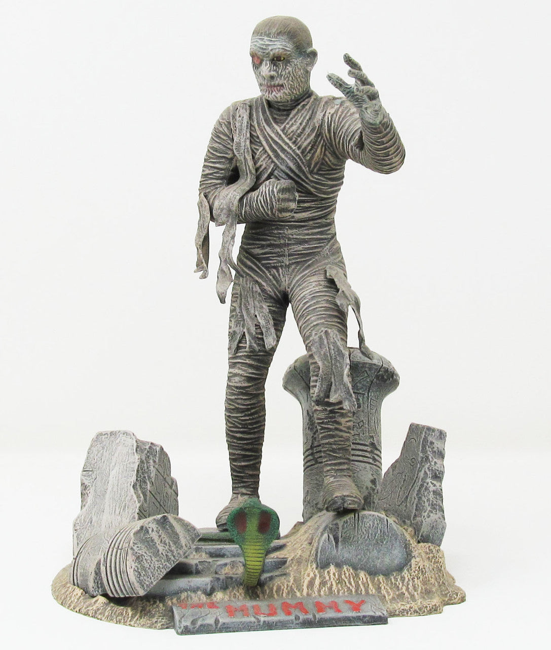 Atlantis Glow in the Dark Mummy Model Kit 1/8 Scale Aurora Tooling USA Made by Atlantis Models on display with tombstone base