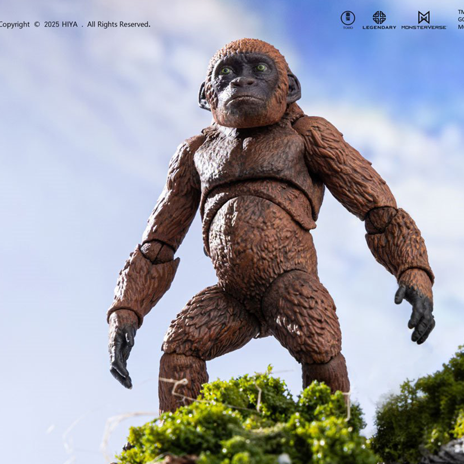 Articulated ape figure with textured brown fur and green eyes posed on mossy terrain against a cloudy sky background