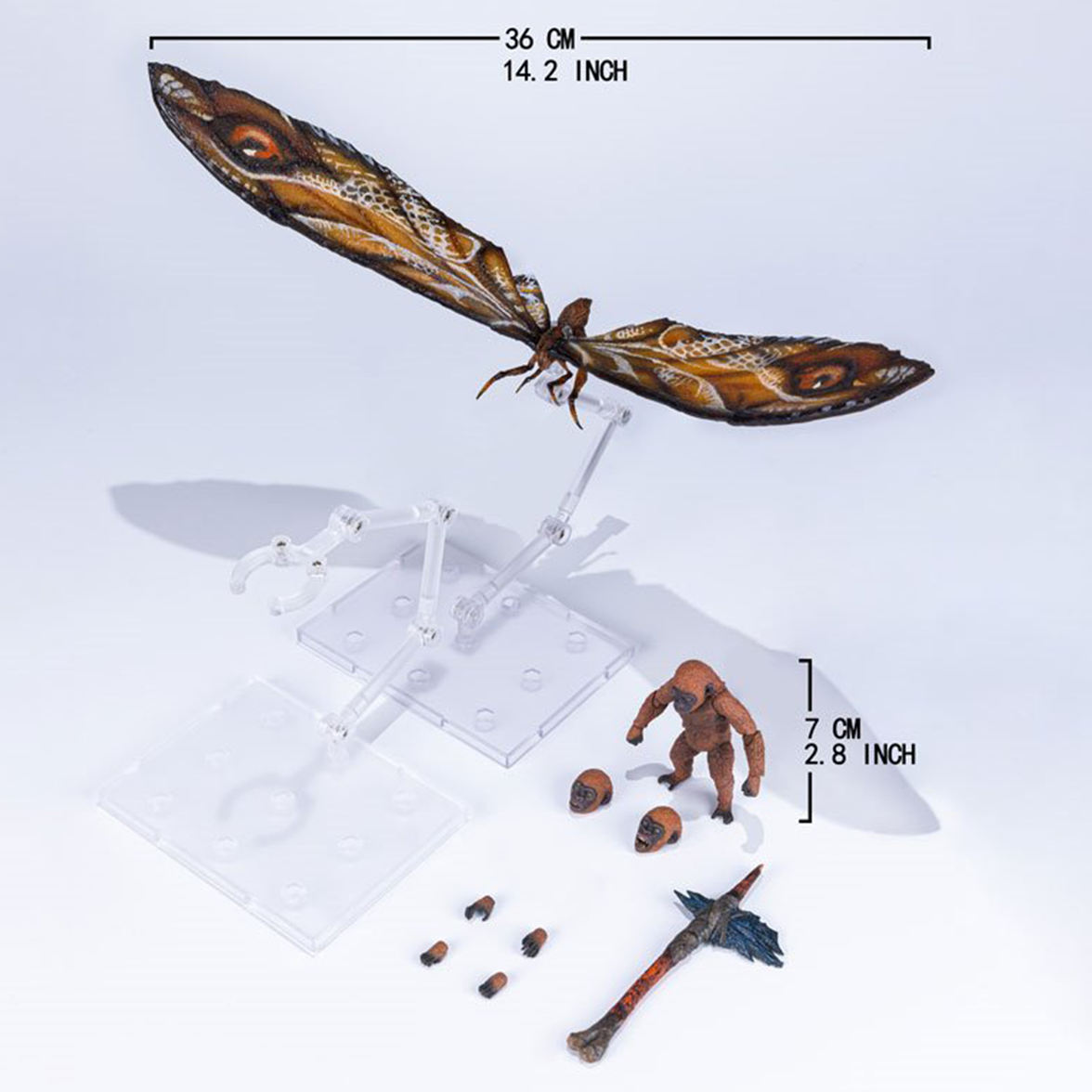 Articulated moth figure with outstretched wings displayed on clear stand alongside small humanoid figure and accessories on white surface