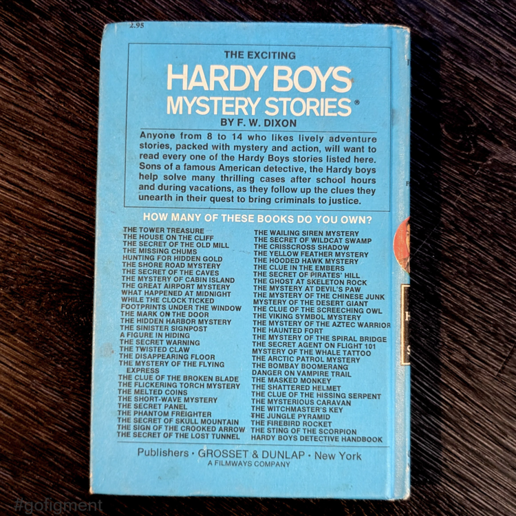 Back cover of vintage 1959 Hardy Boys book listing titles in white text on blue Grosset & Dunlap hardcover
