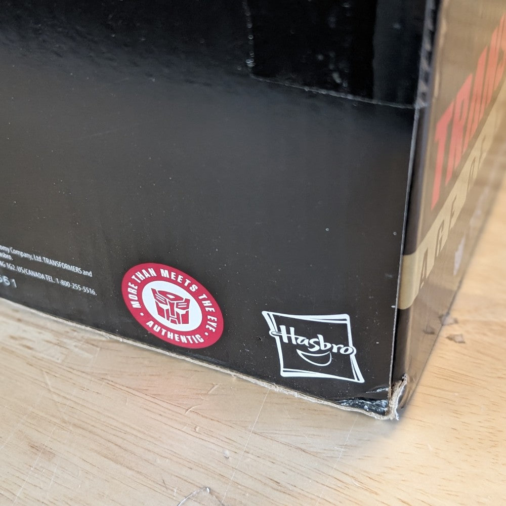 Hasbro logo and Authentic Transformers badge on black Transformers Generations Selects Age of the Primes box corner