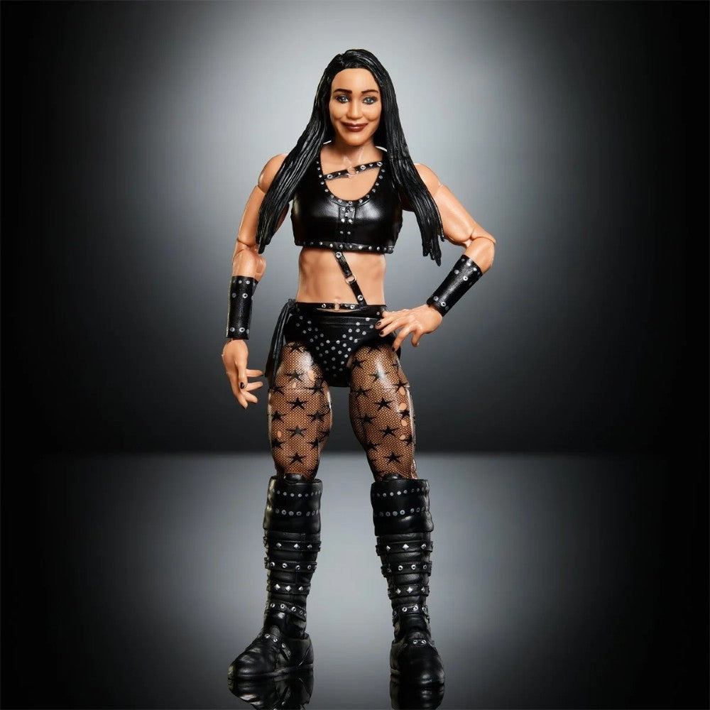 Female wrestling action figure in a black outfit, studded boots, and star-patterned tights against a dark studio backdrop