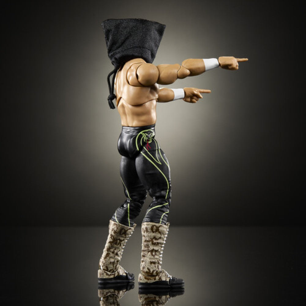 Wrestling action figure in black pants and furry boots, pointing with both arms under a hood