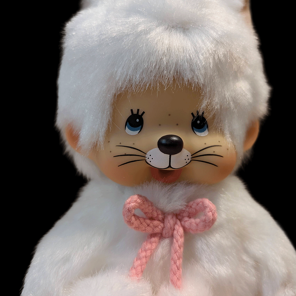 Sekiguchi Monchhichi White Cat Plush with soft fur and pink bow detail close-up on face and upper body