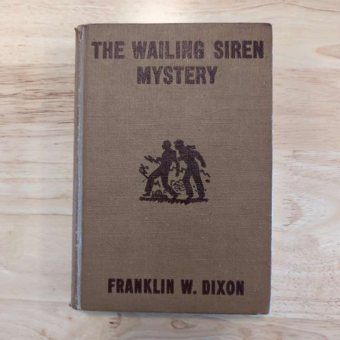 Brown vintage Hardy Boys book titled The Wailing Siren Mystery by Franklin W. Dixon from Grosset & Dunlap, Inc.