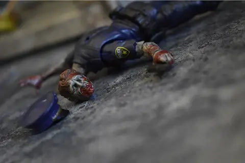 Action Figures and Collectibles by Boss Fight Studio - Vitruvian H.A.C.K.S. Action Figure: Series Z - OFFICER ZED lying on ground with blood details