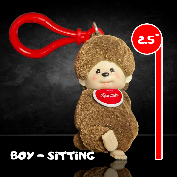 Sekiguchi Monchhichi sitting boy figure with brown flocked vinyl and red clip on black background