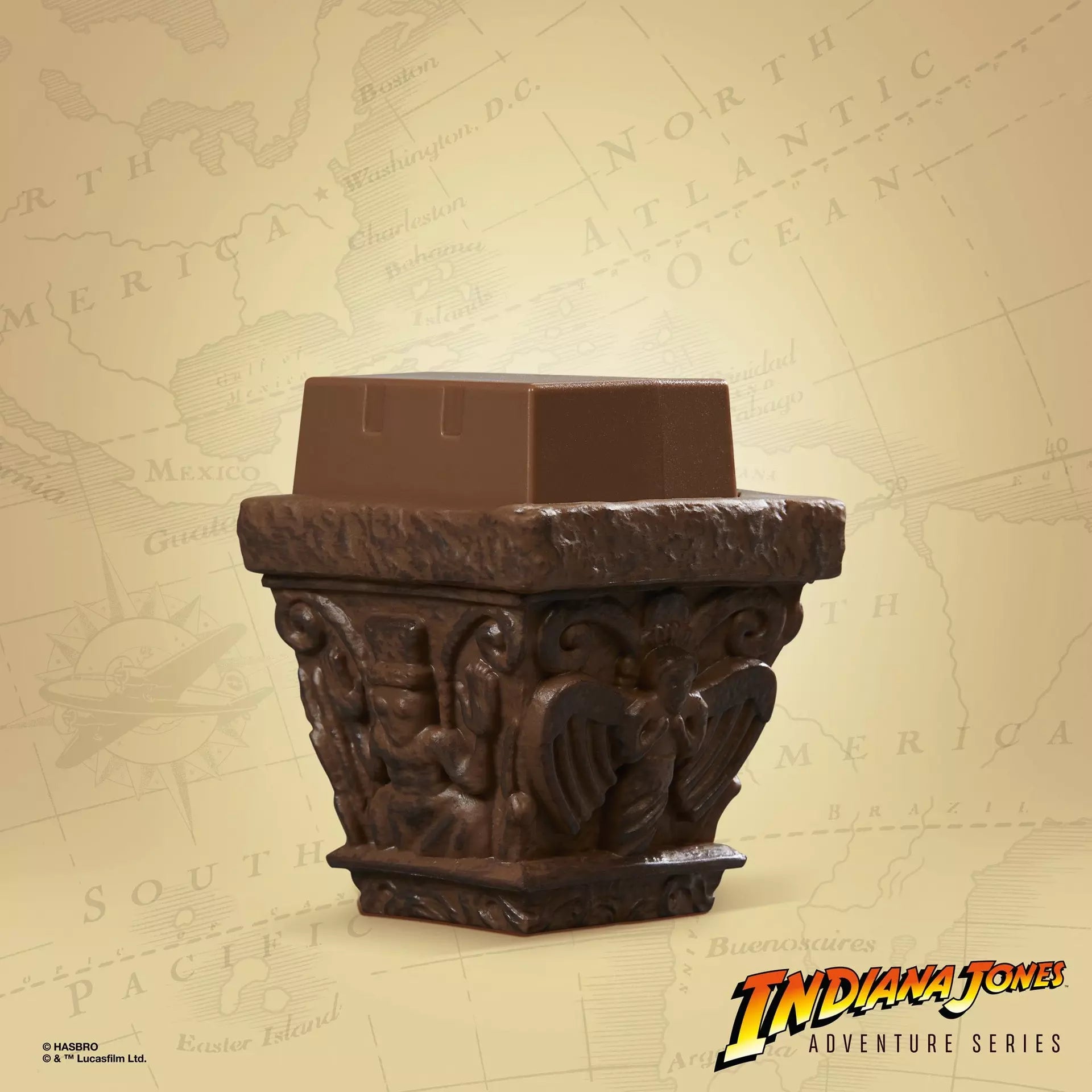 Close-up of Hasbro Indiana Jones Holy Grail Knights Table artifact piece with detailed sculpted designs on tan map background