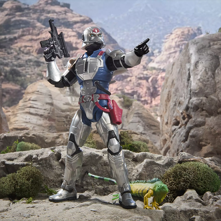 G.I. Joe Classified Series Cobra Commander action figure in silver combat armor posed outdoors with weapon and pet iguana.