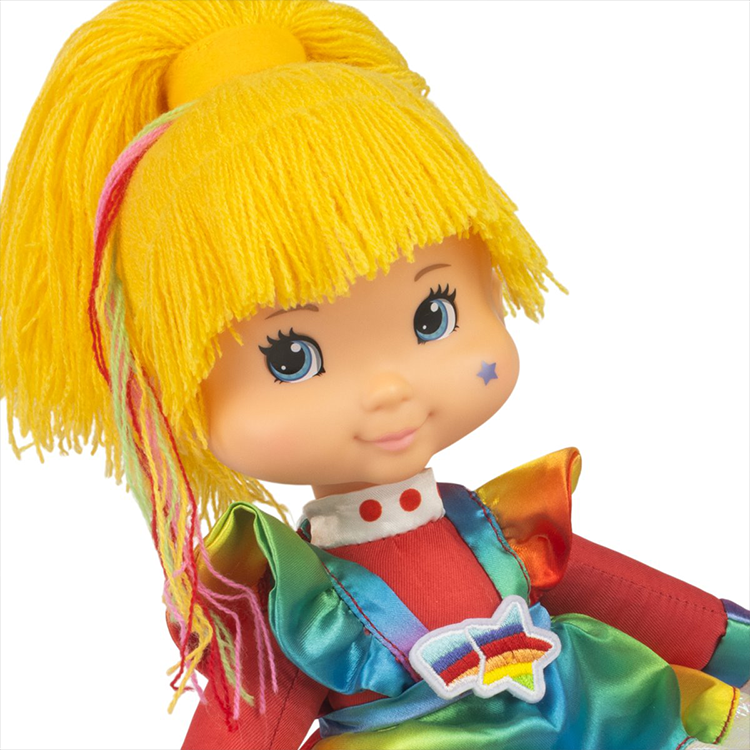 Close-up of Rainbow Brite 12-inch plush doll by The Loyal Subjects wearing vibrant dress-up outfit with yellow yarn hair