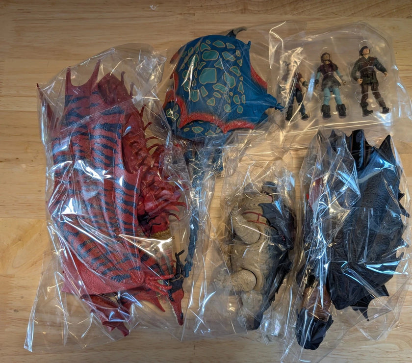 Unboxed How to Train Your Dragon Final Battle 4 Figure Set with detailed dragons and Viking riders in plastic packaging