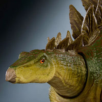 Close-up of Mattel Jurassic World Hammond Collection Stegosaurus dinosaur figure with detailed textured skin and glass eyes