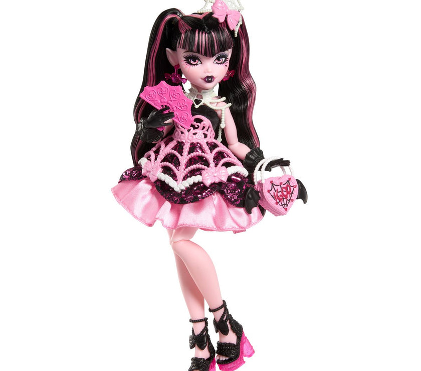 Mattel Monster High Draculaura doll in pink and black spiderweb dress with accessories for a spooky birthday party.