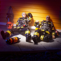 Hasbro GI Joe Classified Series firefighter figure in black and yellow gear sitting with fire extinguisher and equipment