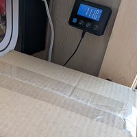 Sealed cardboard box on digital scale reading 11 pounds ready for Playskool My Buddy doll international shipment