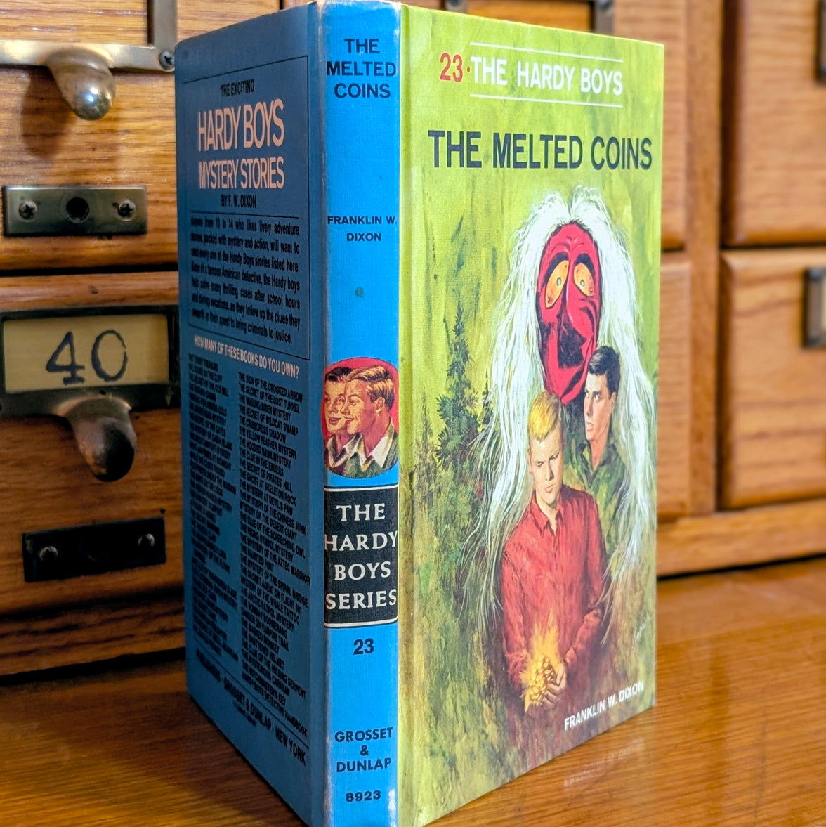 Vintage Hardy Boys book The Melted Coins 23 from 1970 by Grosset & Dunlap with blue spine and illustrated cover