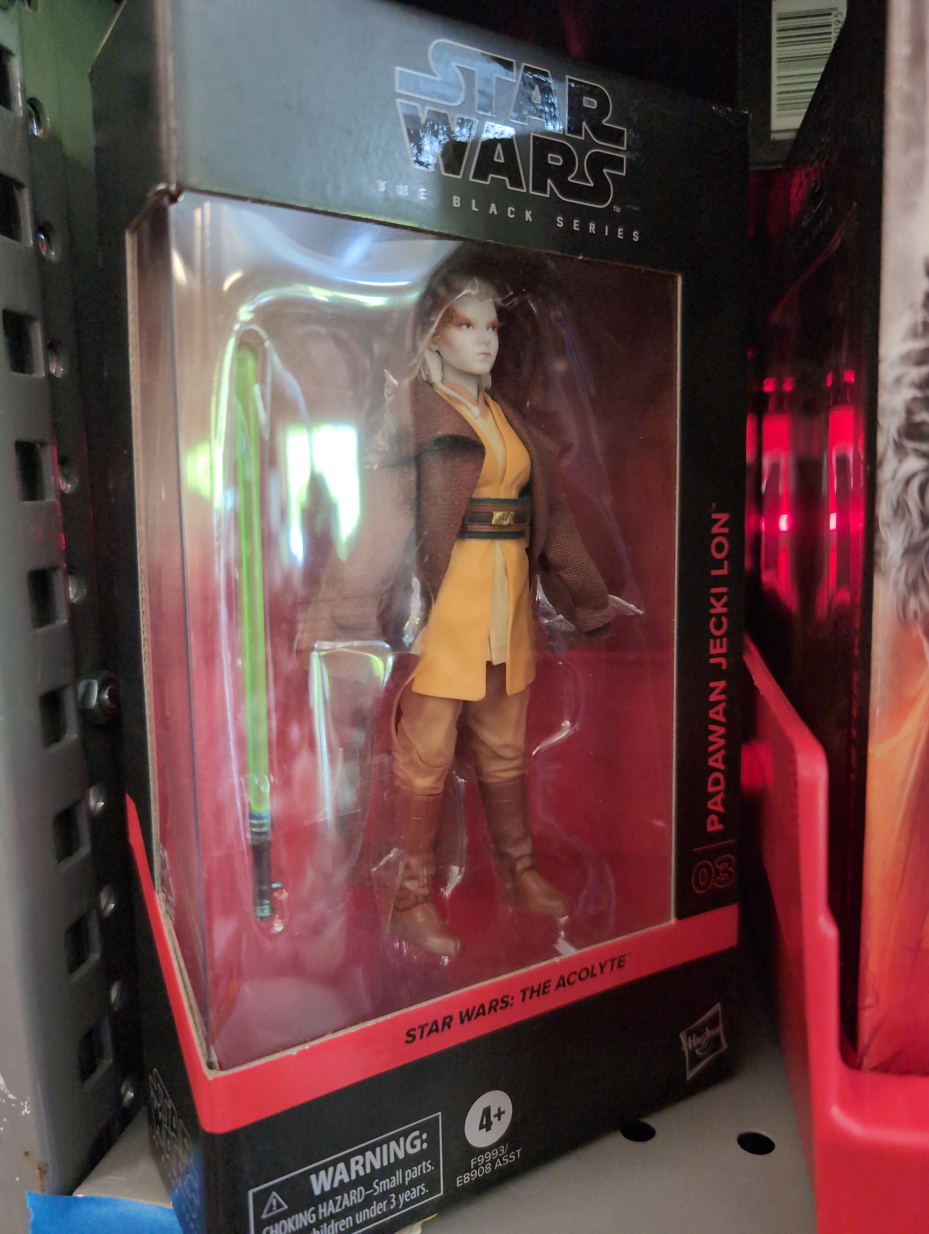 Padawan Jecki Lon Action Figure Star Wars Black Series 1:12 Scale by Hasbro in detailed brown and yellow Jedi outfit.