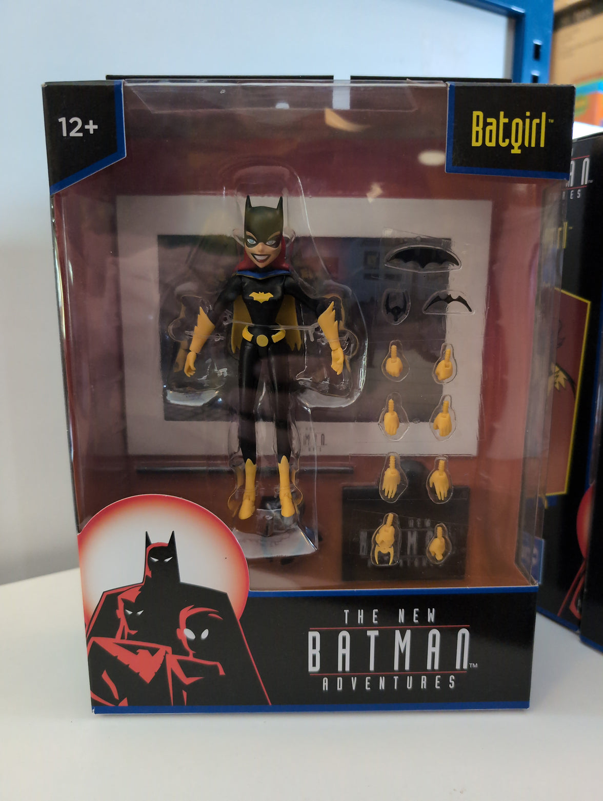 McFarlane Batgirl 6-inch action figure from The New Batman Adventures with multiple hands and accessories in display box.