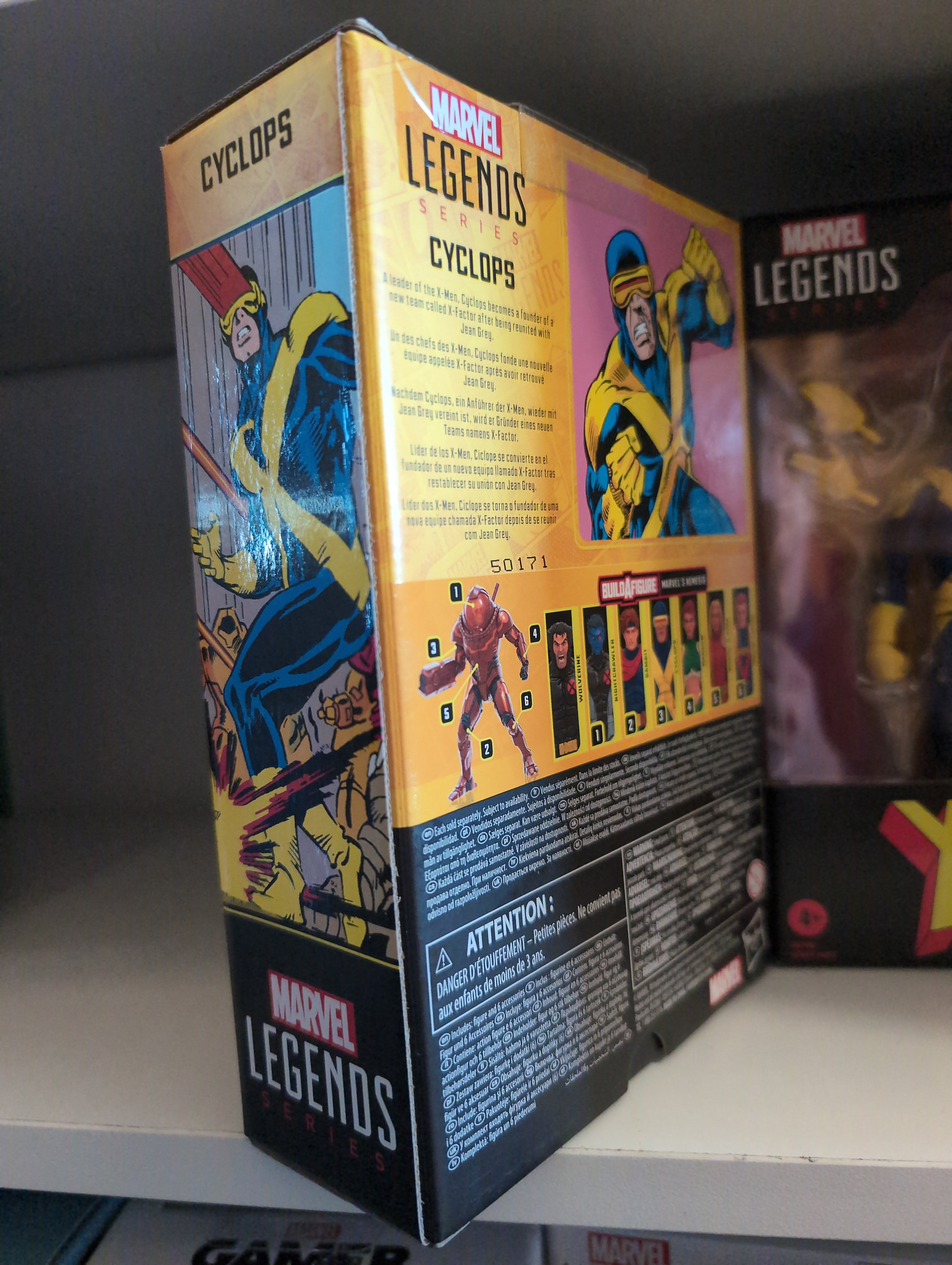 Hasbro Marvel Legends Cyclops action figure packaging featuring comic art and character details on shelf display.