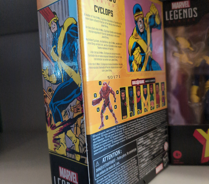 Hasbro Marvel Legends Cyclops action figure packaging featuring comic art and character details on shelf display.