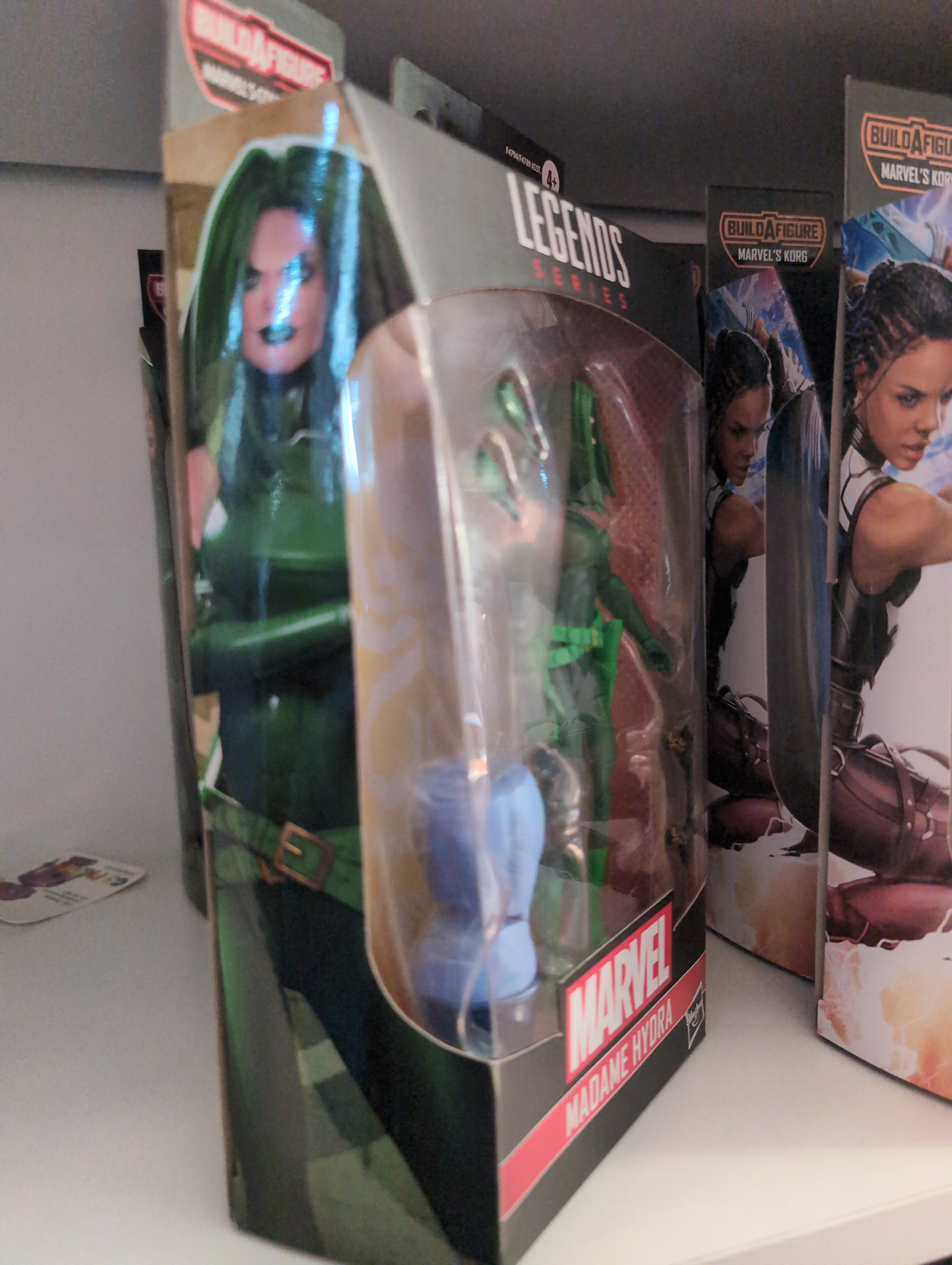 Hasbro Marvel Legends Madame Hydra action figure in classic green outfit with pistols and alternate hands in packaging
