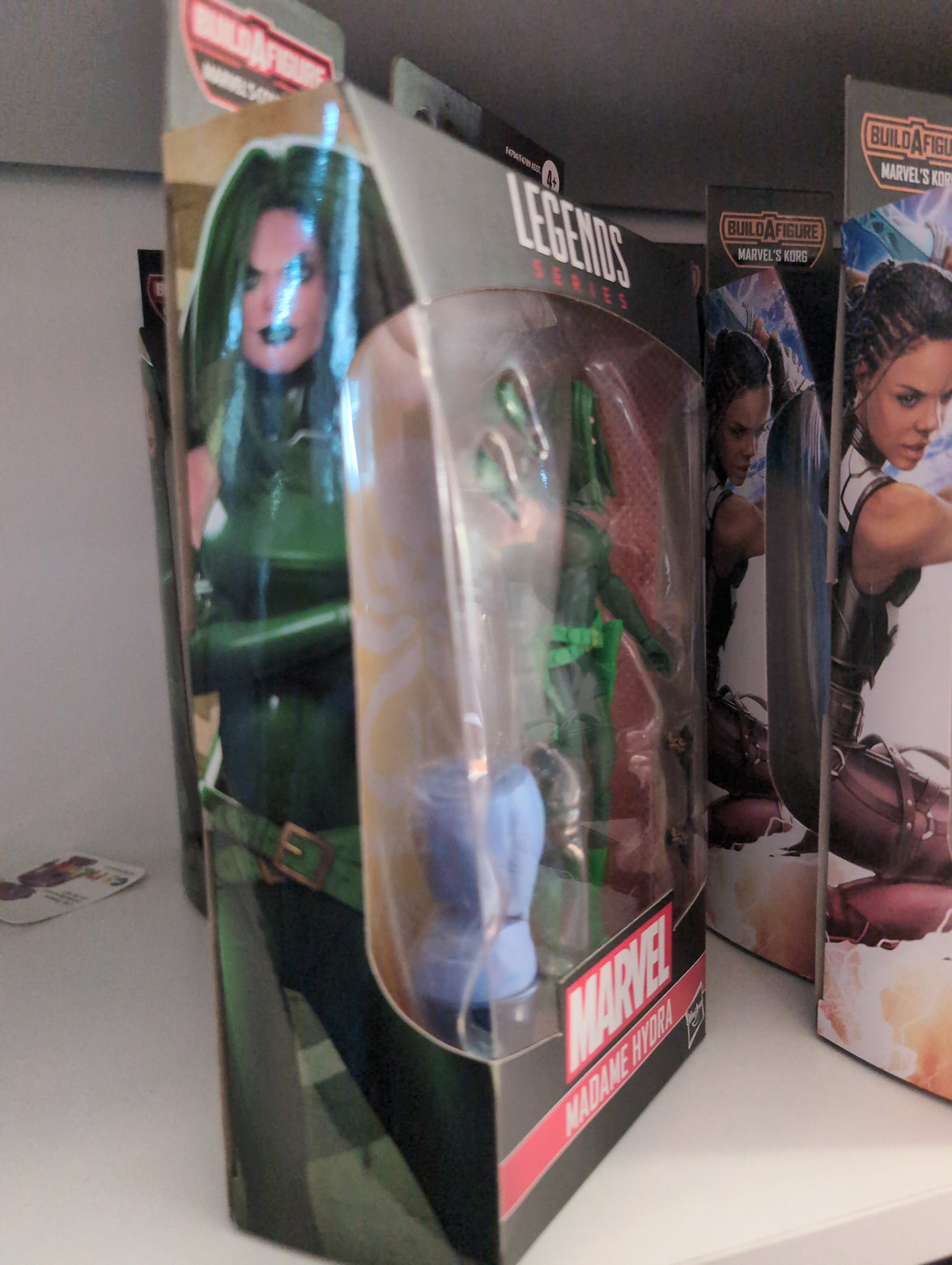 Hasbro Marvel Legends Madame Hydra action figure in classic green outfit with pistols and alternate hands in packaging