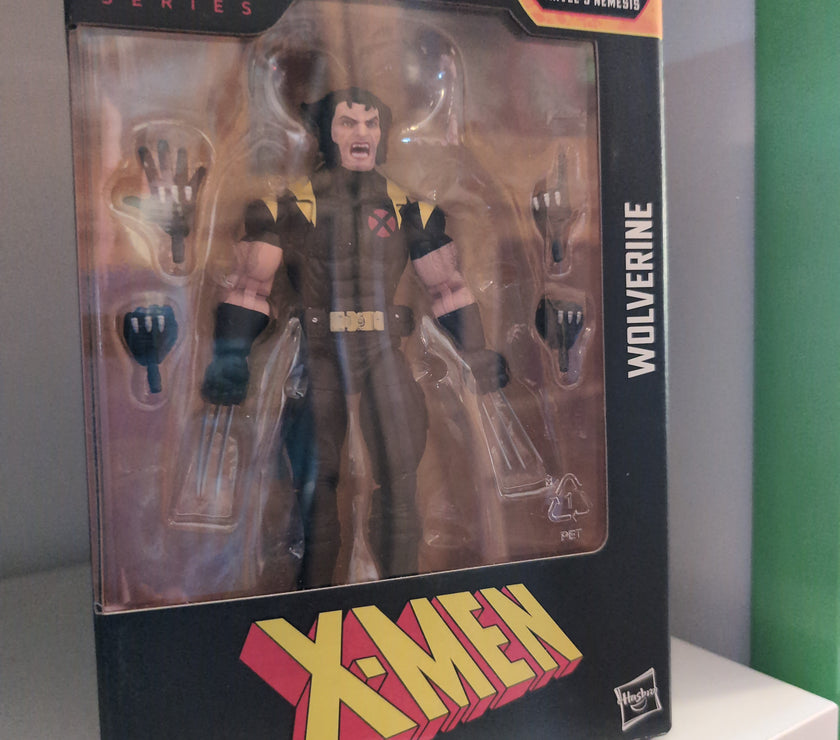 Hasbro Marvel Legends Wolverine X-Men 6-inch action figure with multiple hands in original packaging.