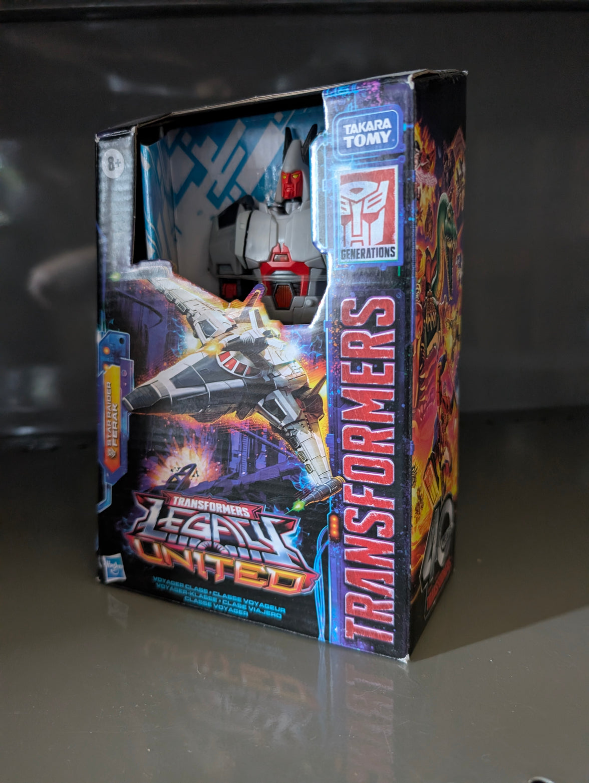 Voyager Star Raider Transformers Legacy United Collectable Action Figure by Hasbro in original packaging with spaceship design art.