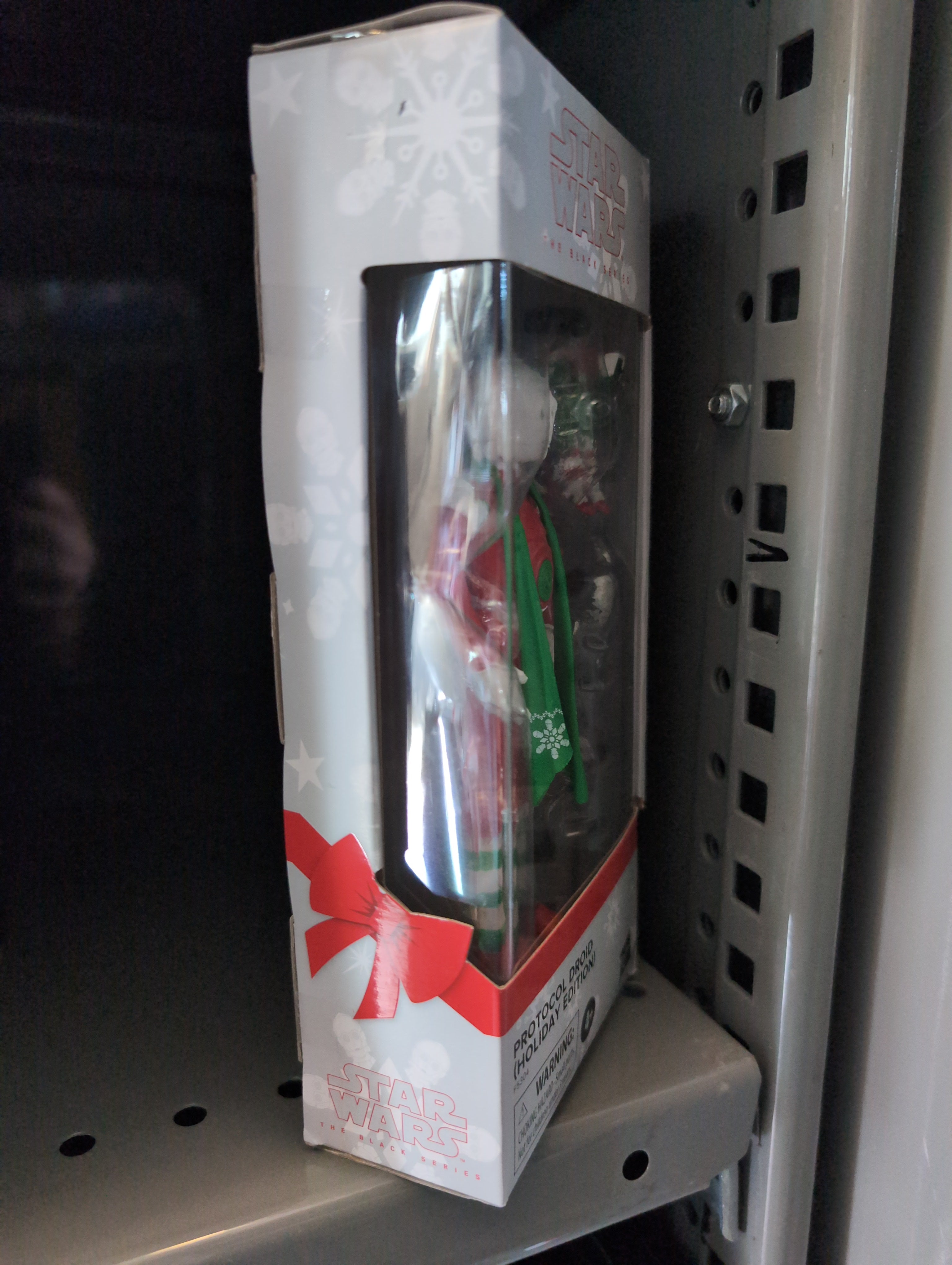 Hasbro Star Wars Black Series Christmas Protocol Droid 1:12 scale action figure in festive packaging on store shelf