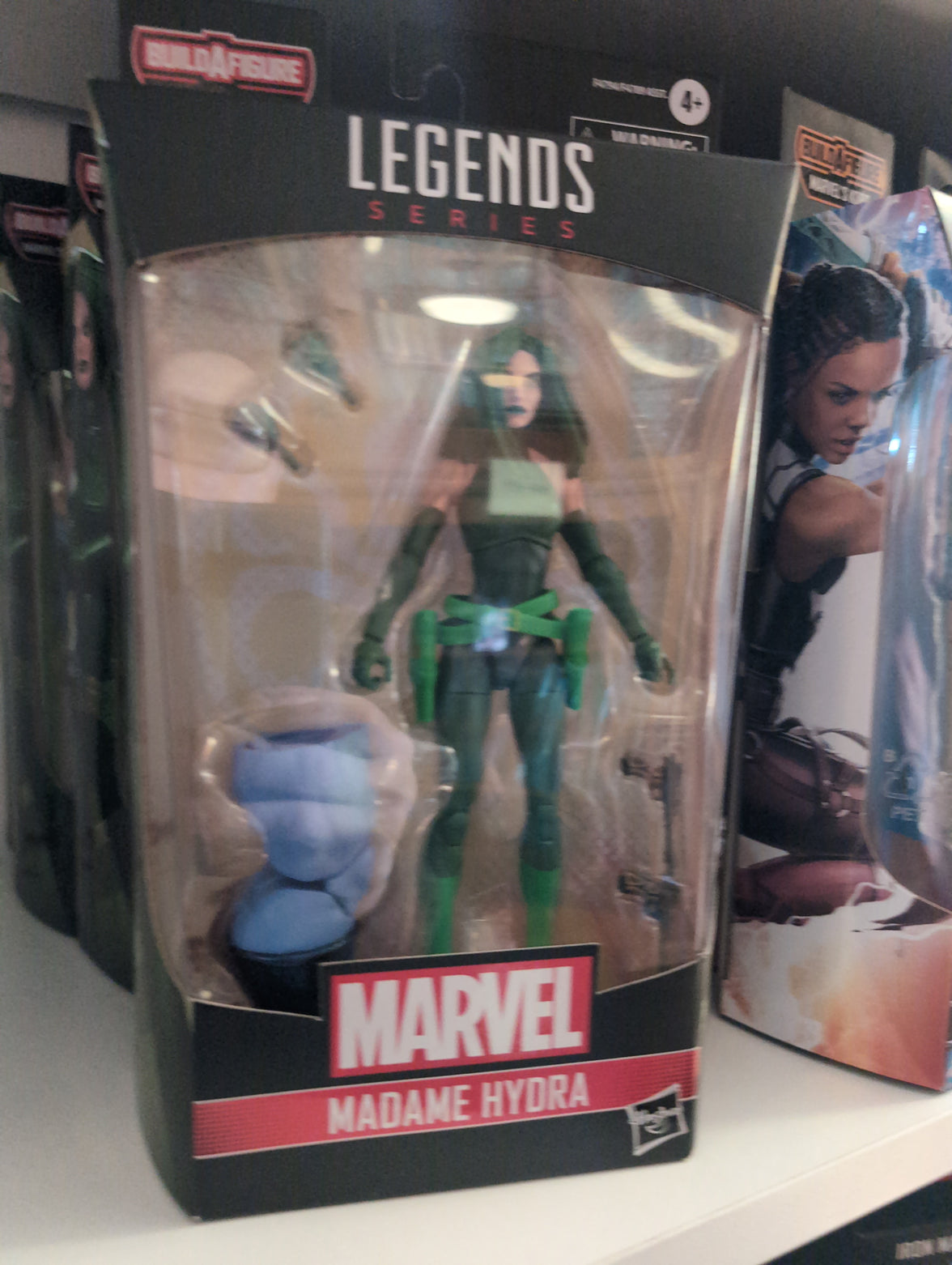 Hasbro Marvel Legends Madame Hydra action figure with accessories and Build-A-Figure piece in collectible packaging.