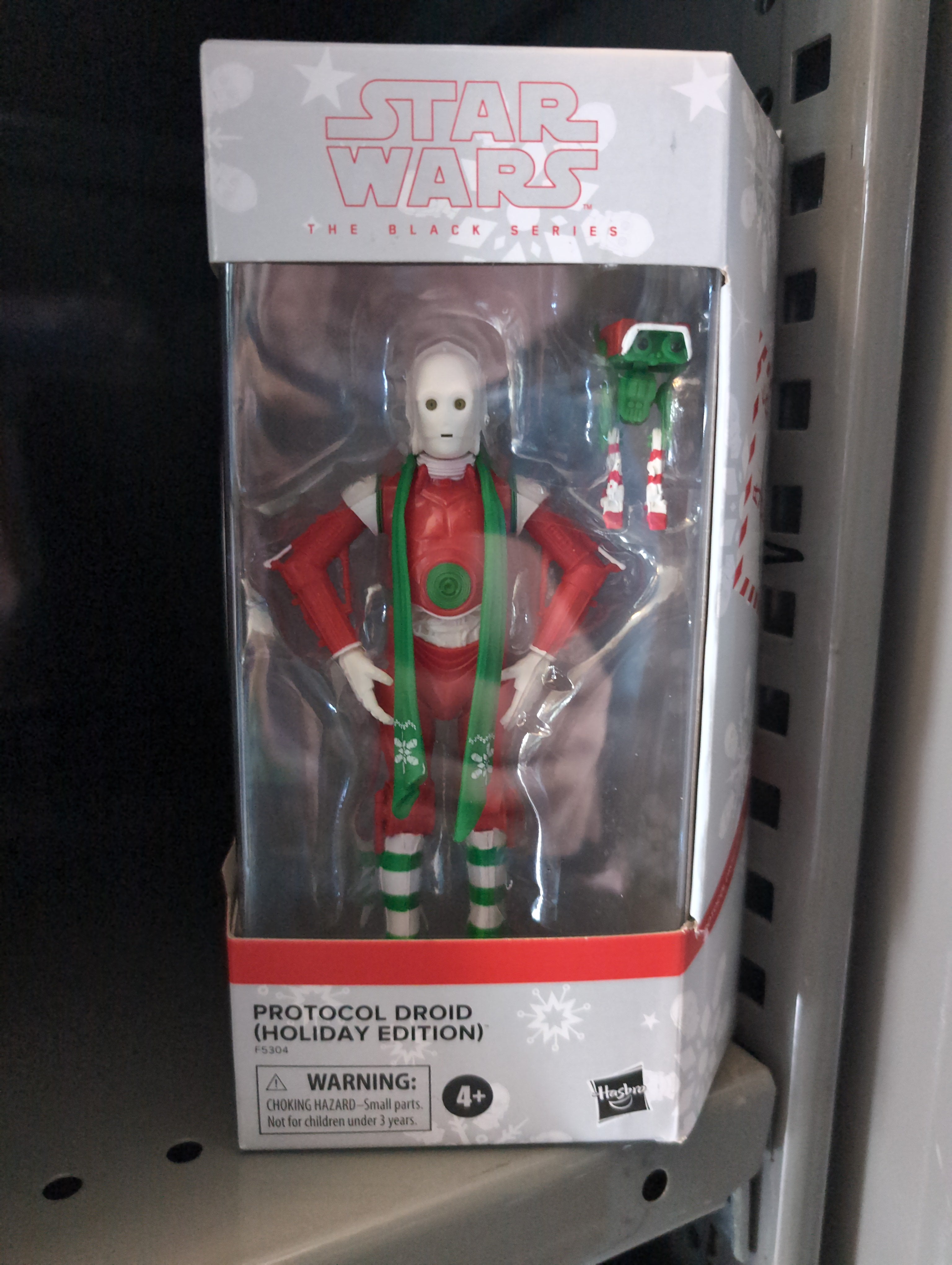 Hasbro Star Wars Black Series Christmas Protocol Droid action figure in holiday-themed red and green display box