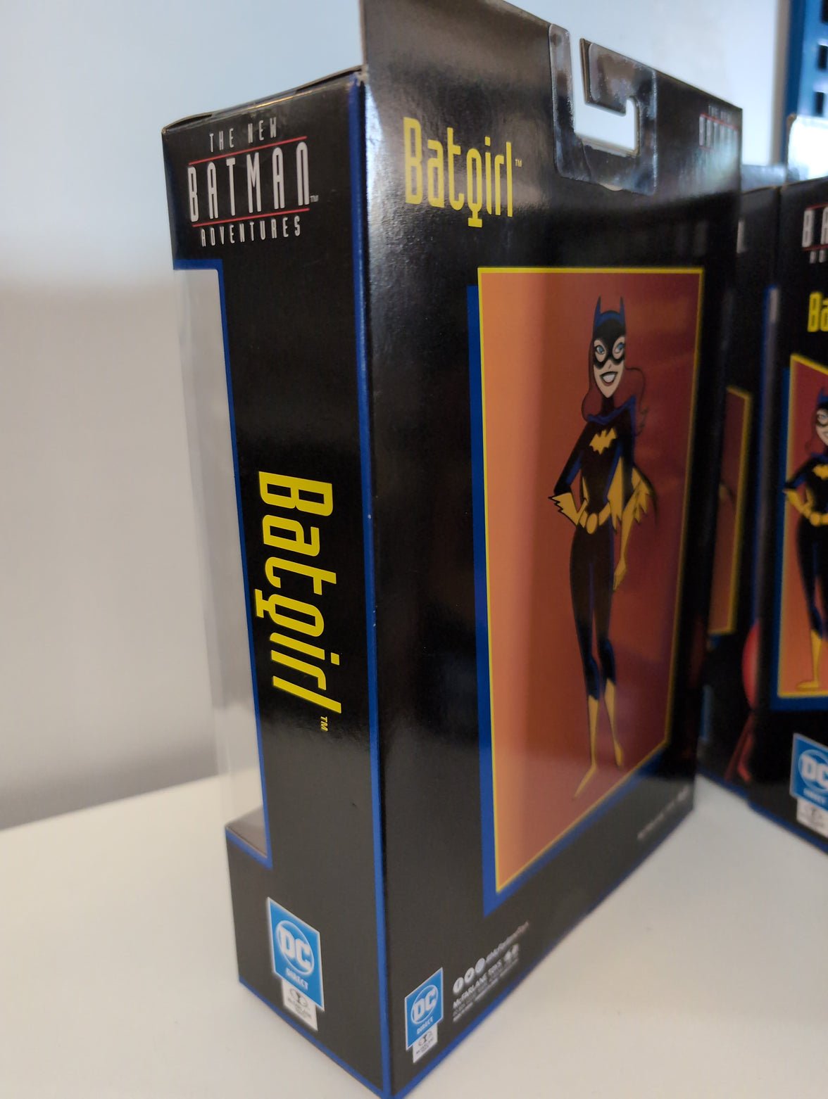 McFarlane Toys Batgirl action figure packaging from The New Batman Adventures series with classic character art on box.