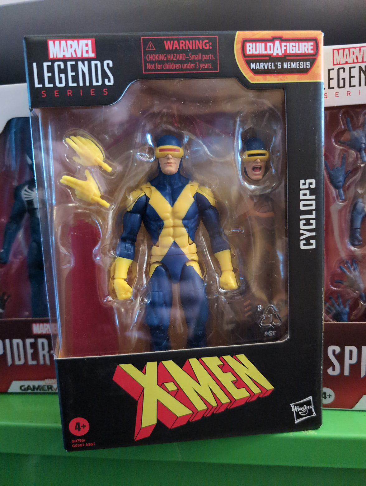 Hasbro Marvel Legends Cyclops X-Men action figure with interchangeable heads and hand accessories in collector packaging
