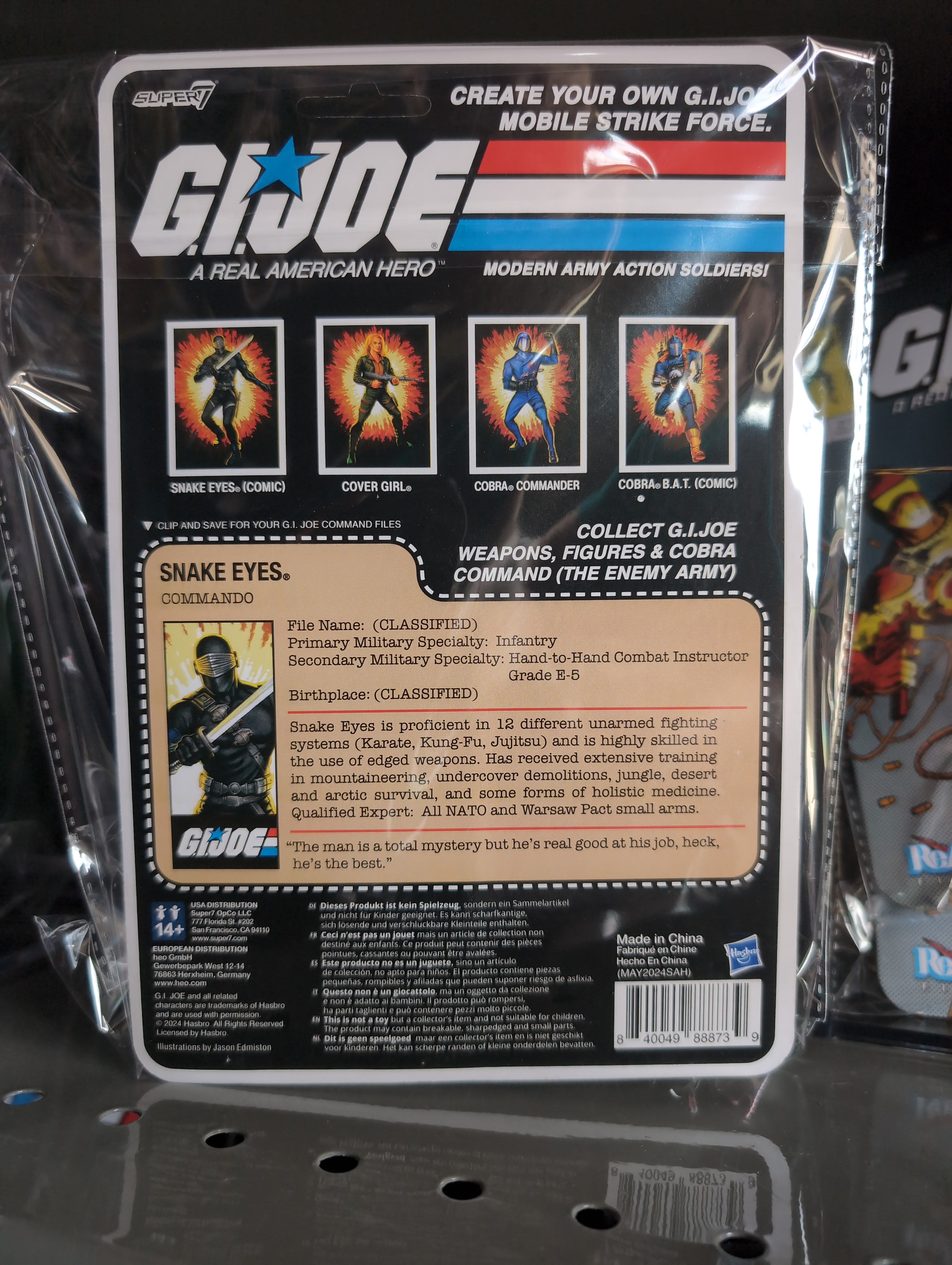 Hasbro Snake Eyes G.I. Joe action figure in black tactical gear with sword and blaster in vintage packaging