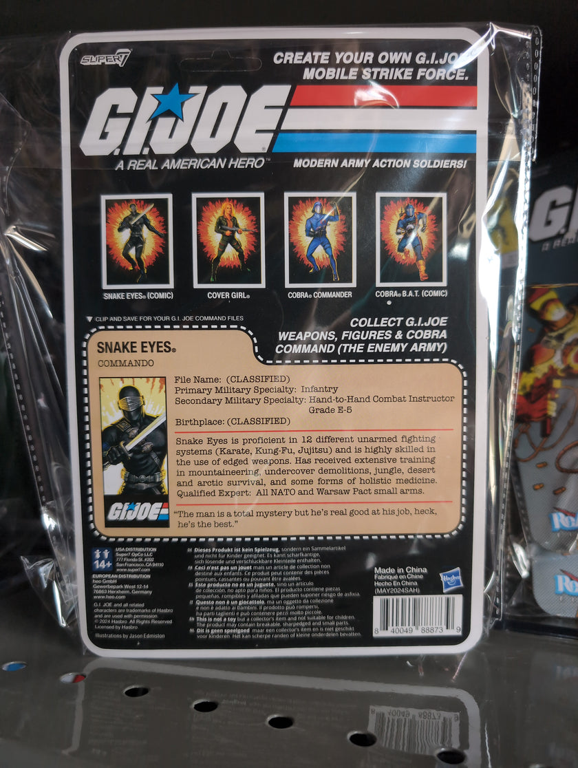 Hasbro Snake Eyes G.I. Joe action figure in black tactical gear with sword and blaster in vintage packaging