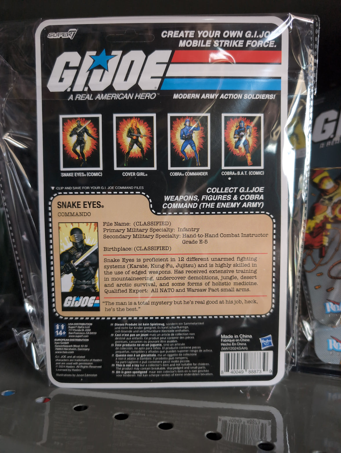 Hasbro Snake Eyes G.I. Joe action figure in black tactical gear with sword and blaster in vintage packaging