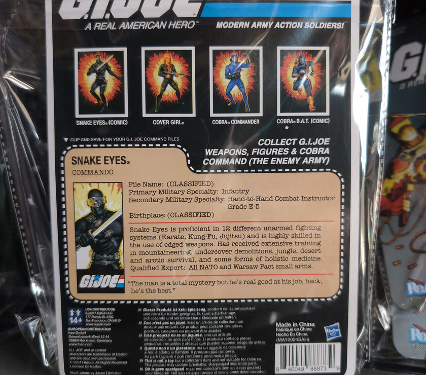 Hasbro Snake Eyes G.I. Joe action figure in black tactical gear with sword and blaster in vintage packaging