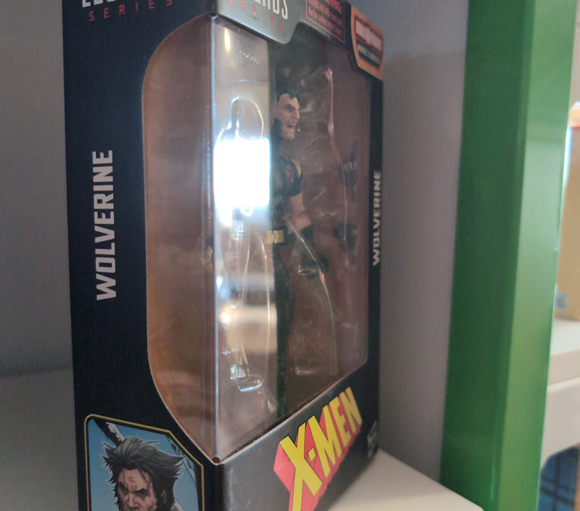 Hasbro Marvel Legends Wolverine X-Men 6-inch action figure in packaging with accessories visible on shelf