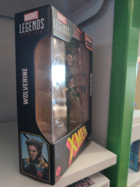 Hasbro Marvel Legends Wolverine X-Men 6-inch action figure in packaging with accessories visible on shelf