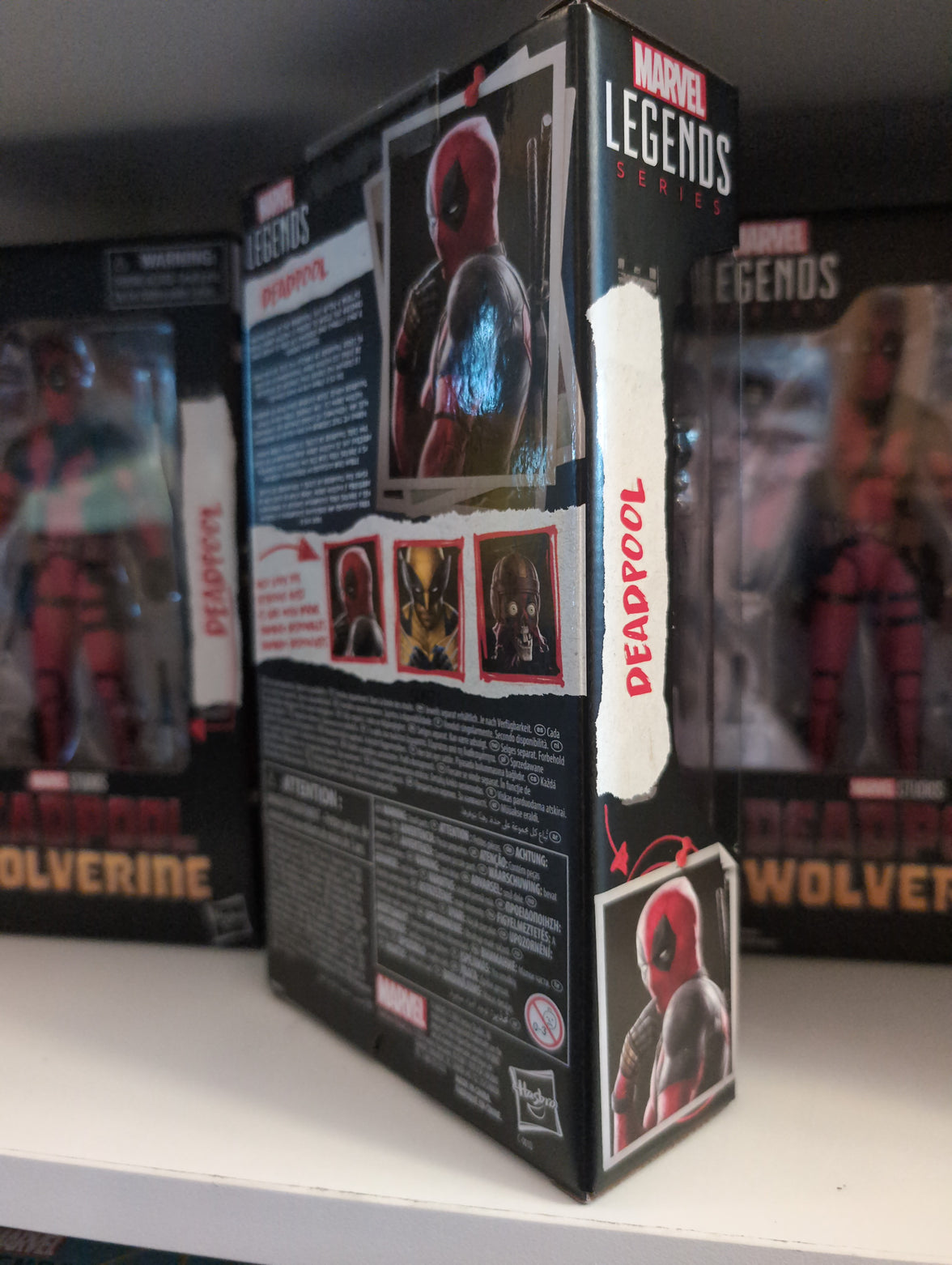 Deadpool Marvel Legends 6-inch action figure packaging by Hasbro displayed with Wolverine figures behind.