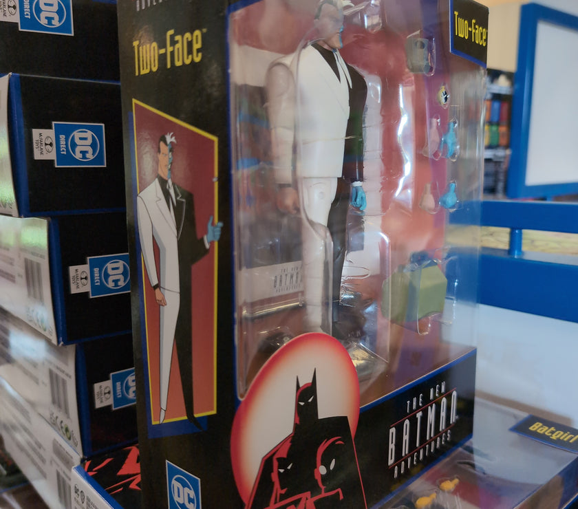 McFarlane Two-Face action figure from The New Batman Adventures in packaging with accessories and display base visible.