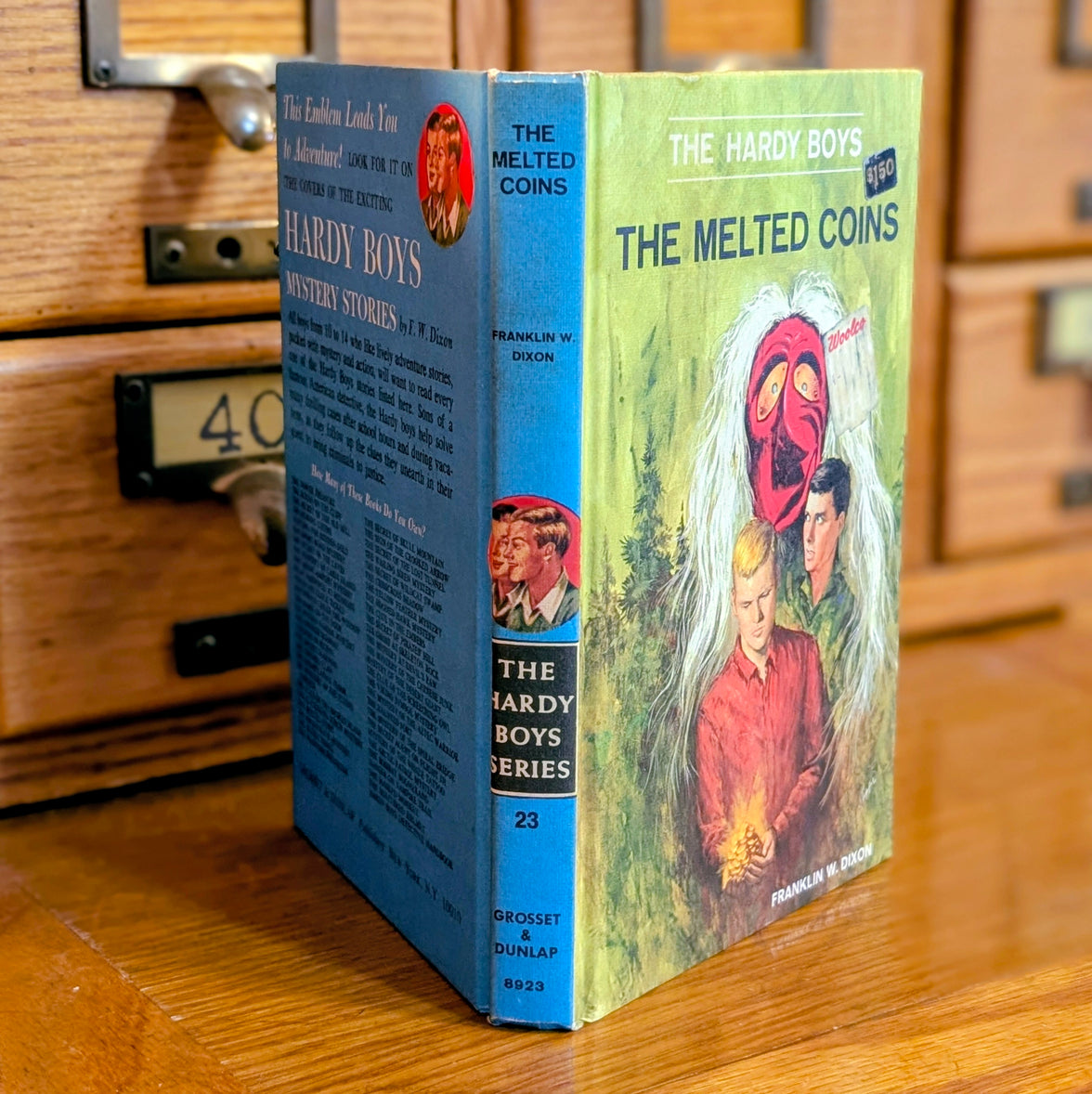 Vintage 1970 Hardy Boys book The Melted Coins by Grosset & Dunlap, Inc. with blue back cover and illustrated front