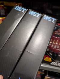 Stack of three black BET branded boxes shown with part of Hasbro GI Joe Night Force figures in background