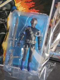 Hasbro Snake Eyes G.I. Joe ReAction+ figure in black tactical gear with sword and blaster accessories in packaging