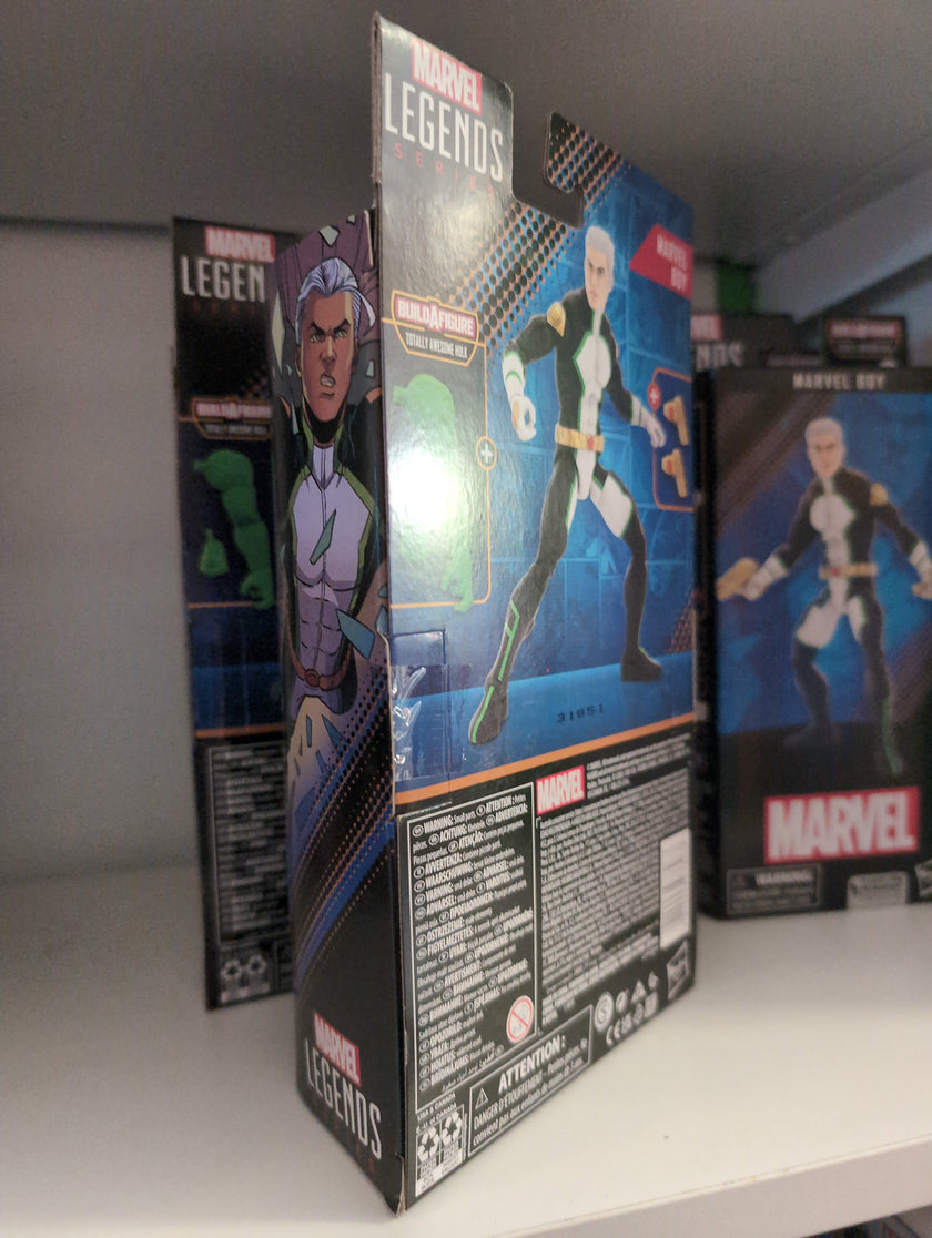Hasbro Marvel Legends Marvel Boy action figure packaging displayed on a store shelf with artwork and accessories visible